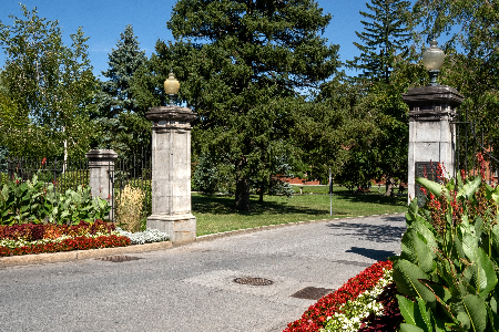 Stone pillars at park entrance in Saratoga Springs with landscaped gardens