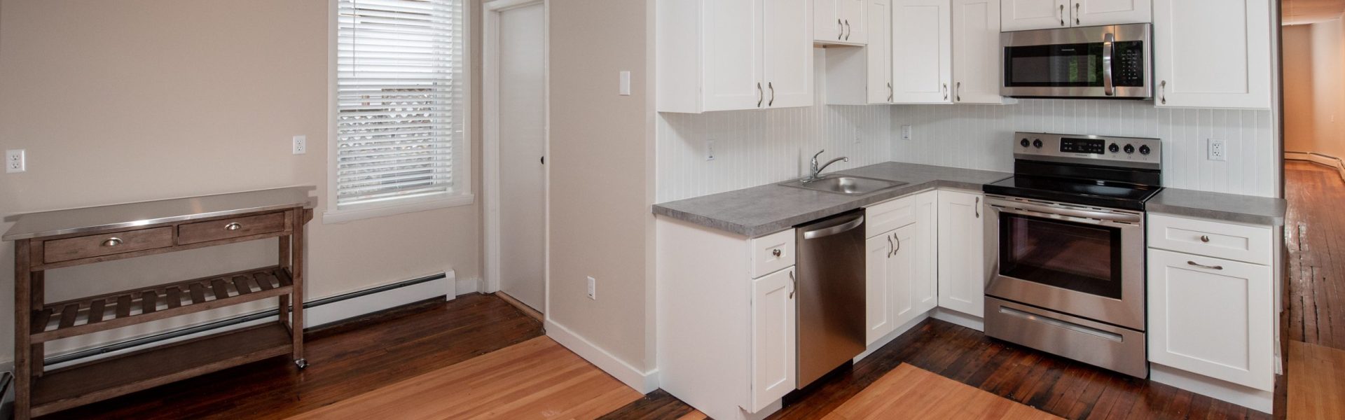 Interior view of a renovated 2-bedroom rental apartment at 19 Warsaw Ave in Mechanicville, NY located inside a historic building with updated finishes.