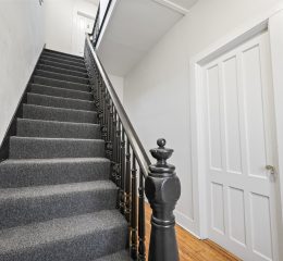 Interior view of a newly renovated 2-bedroom apartment at 58 Lincoln Ave #2 in Saratoga Springs, NY, featuring a balcony, dedicated office space, and modern finishes.