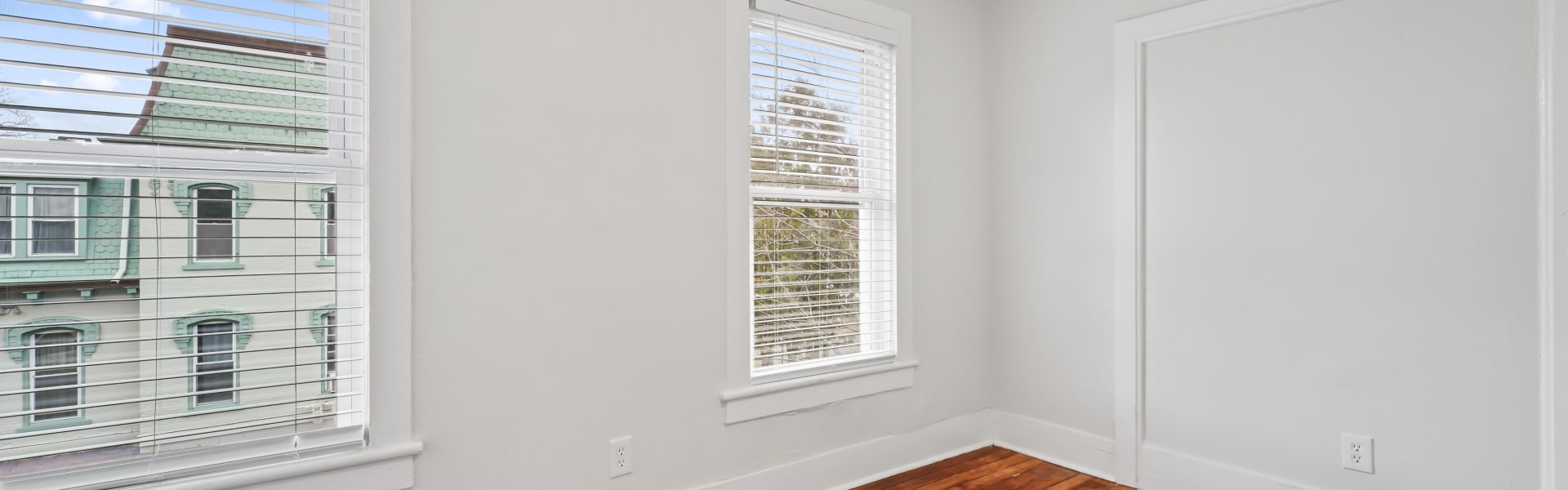 Interior view of a newly renovated 2-bedroom apartment at 58 Lincoln Ave #2 in Saratoga Springs, NY, featuring a balcony, dedicated office space, and modern finishes.
