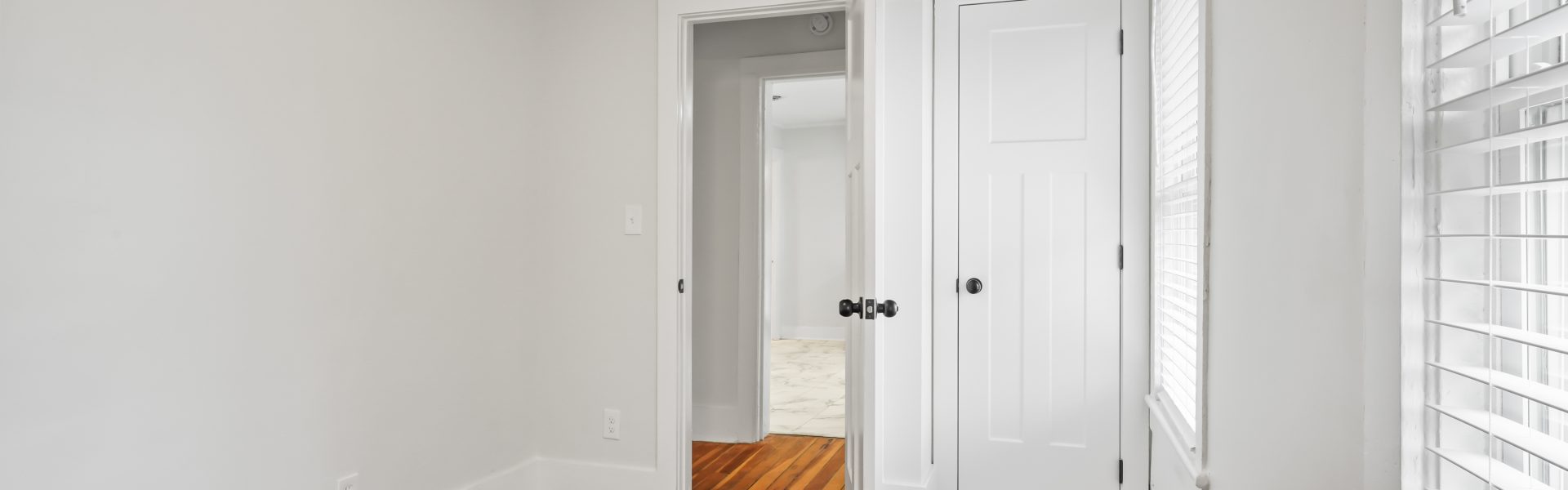 Interior view of a newly renovated 2-bedroom apartment at 58 Lincoln Ave #2 in Saratoga Springs, NY, featuring a balcony, dedicated office space, and modern finishes.