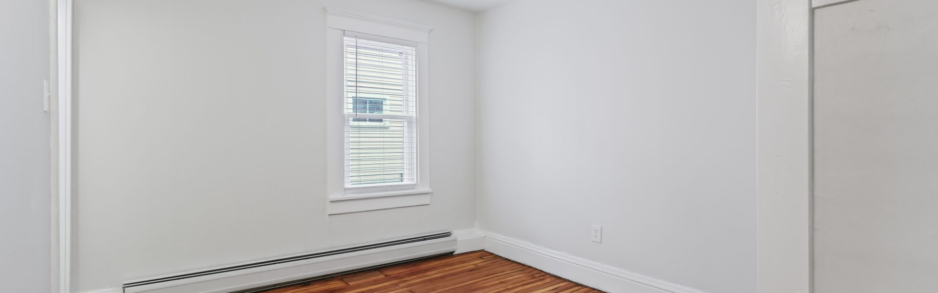 Interior view of a newly renovated 1-bedroom apartment at 2 New St #3 in South Glens Falls, NY with updated flooring and modern finishes.
