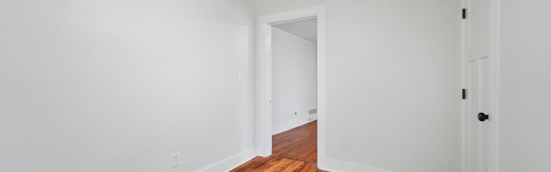 Interior view of a newly renovated 2-bedroom apartment at 58 Lincoln Ave #2 in Saratoga Springs, NY, featuring a balcony, dedicated office space, and modern finishes.