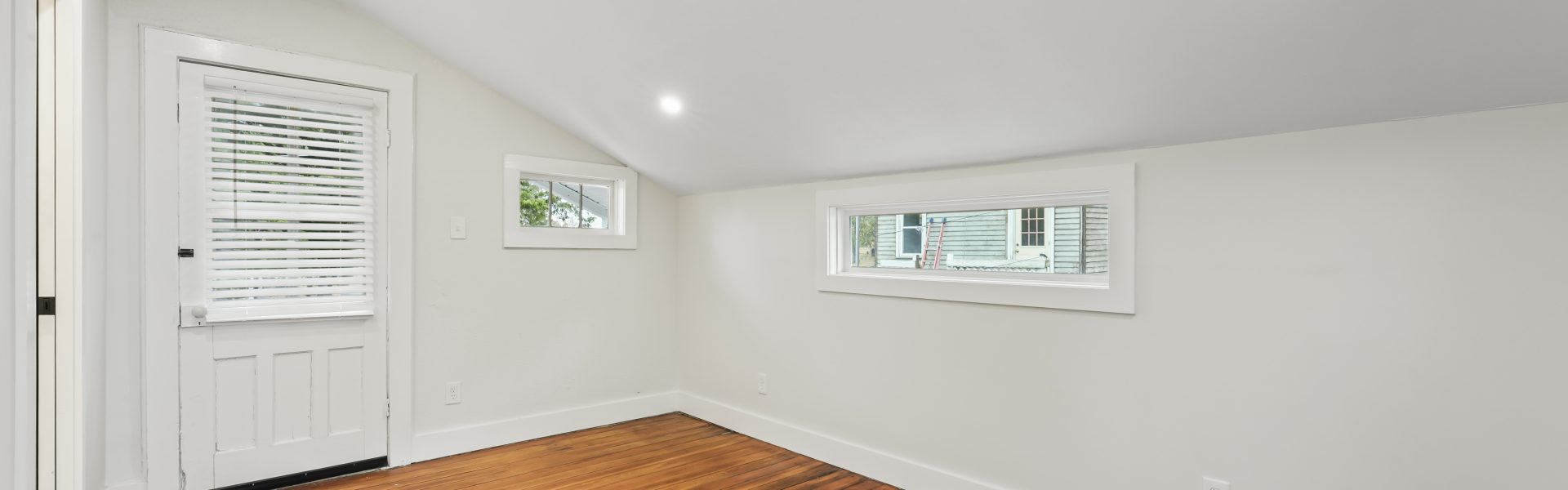 Interior view of a newly renovated 2-bedroom apartment at 58 Lincoln Ave #2 in Saratoga Springs, NY, featuring a balcony, dedicated office space, and modern finishes.