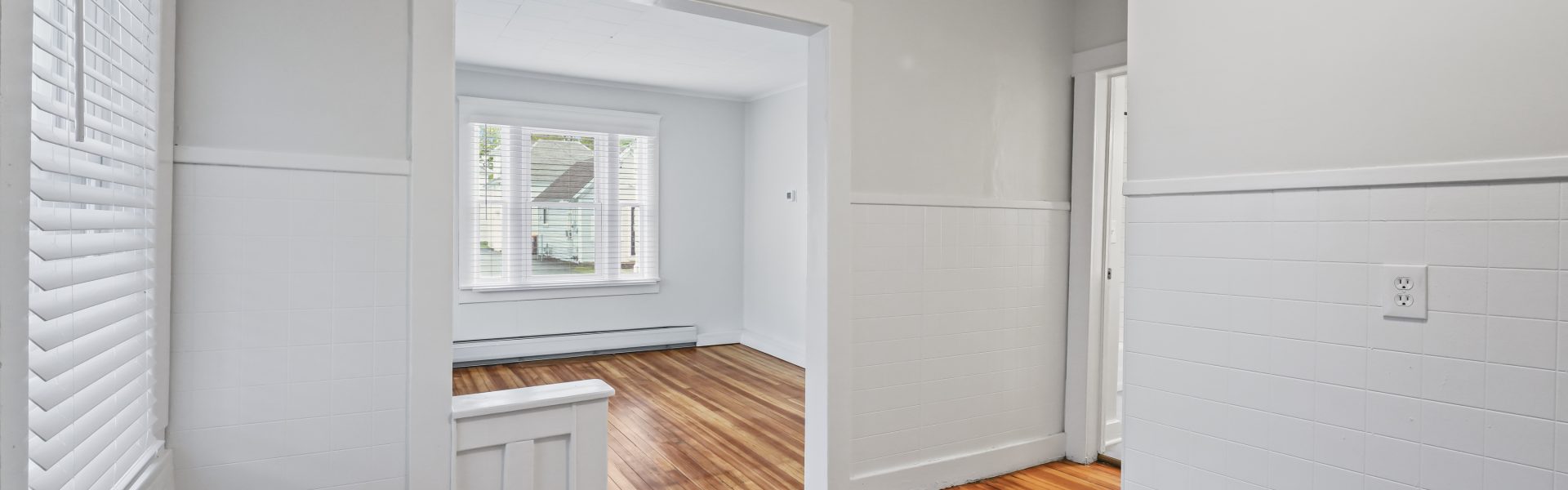 Interior view of a newly renovated 1-bedroom apartment at 2 New St #3 in South Glens Falls, NY with updated flooring and modern finishes.