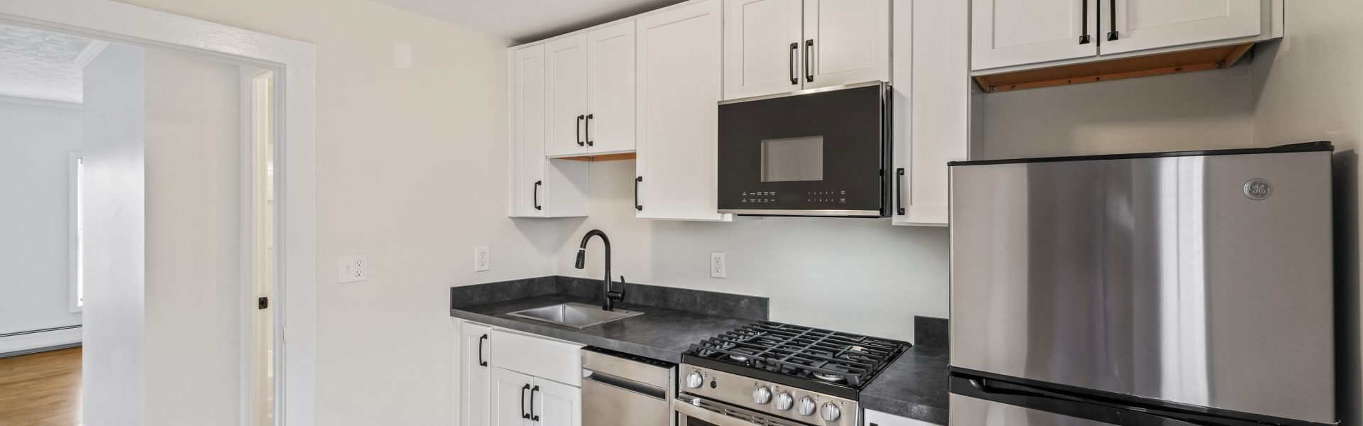 Interior view of a newly renovated 1-bedroom apartment at 35 Saratoga Ave #1 in South Glens Falls, NY, featuring modern finishes and bright natural light.