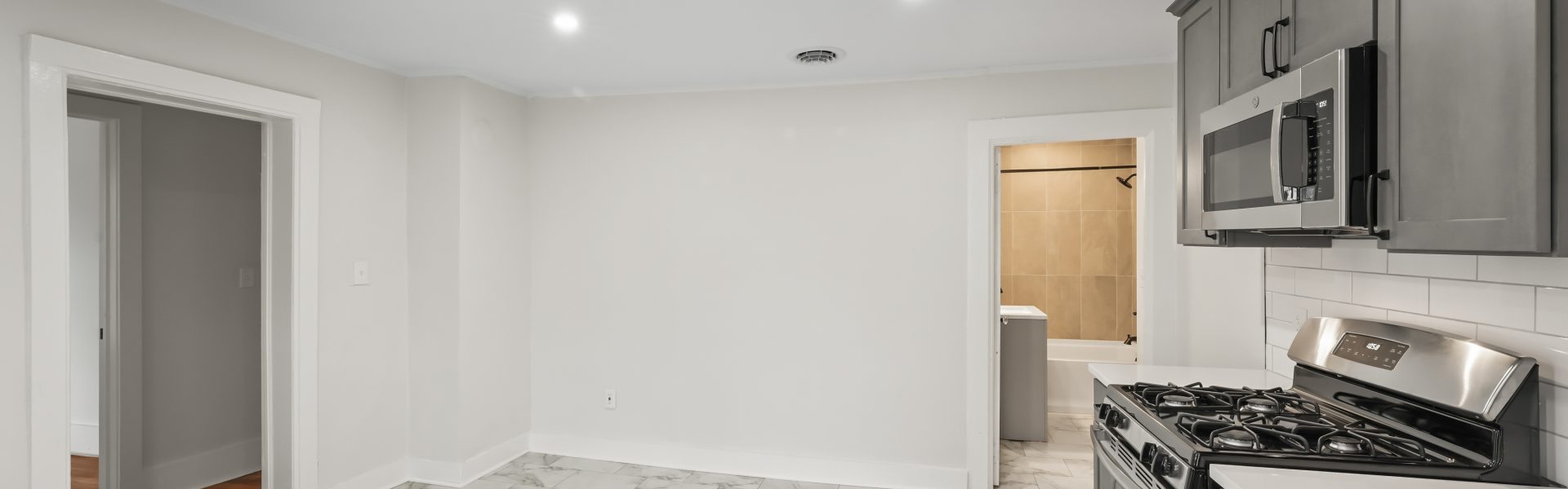 Interior view of a newly renovated 2-bedroom apartment at 58 Lincoln Ave #2 in Saratoga Springs, NY, featuring a balcony, dedicated office space, and modern finishes.