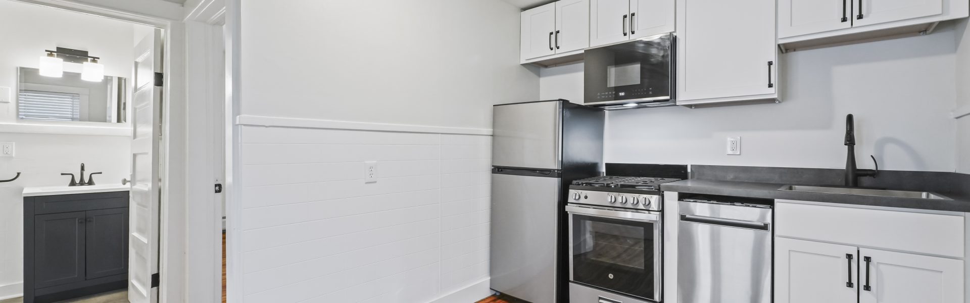 Interior view of a newly renovated 1-bedroom apartment at 2 New St #3 in South Glens Falls, NY with updated flooring and modern finishes.