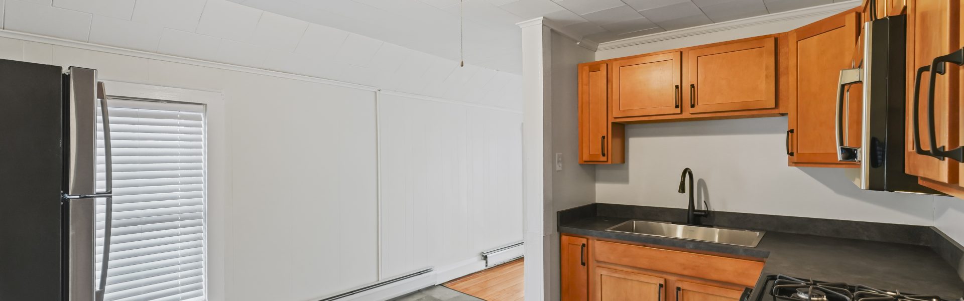 Interior view of a newly renovated 1-bedroom apartment at 2 New St #4 in South Glens Falls, NY, featuring updated flooring, modern finishes, and bright natural light.