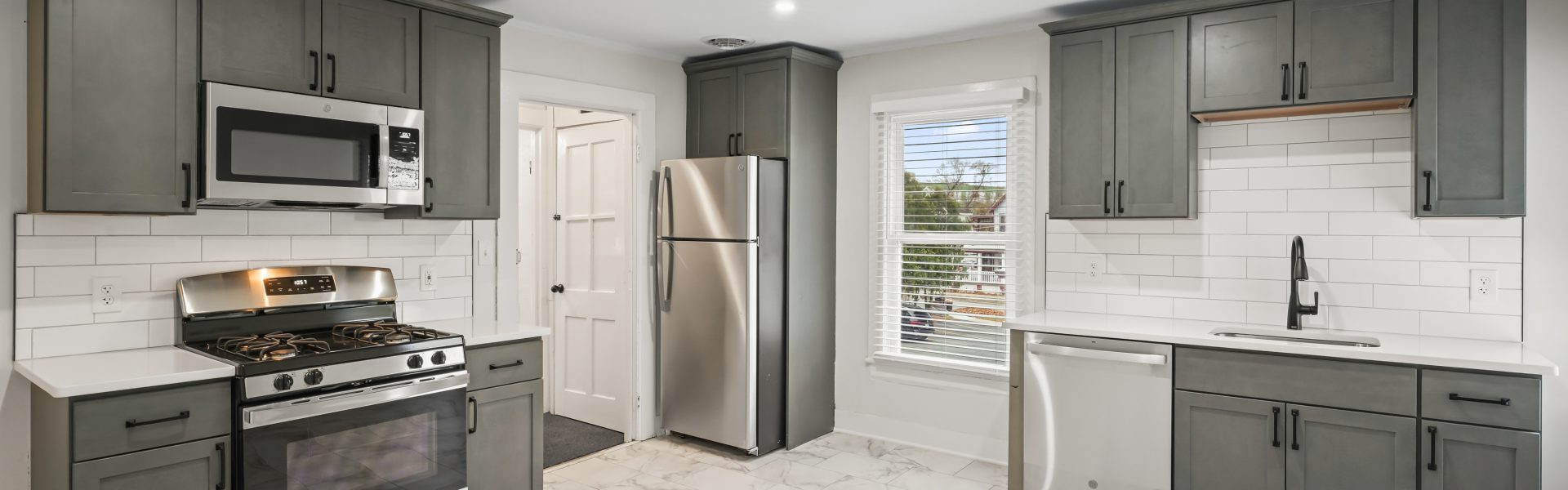 Interior view of a newly renovated 2-bedroom apartment at 58 Lincoln Ave #2 in Saratoga Springs, NY, featuring a balcony, dedicated office space, and modern finishes.