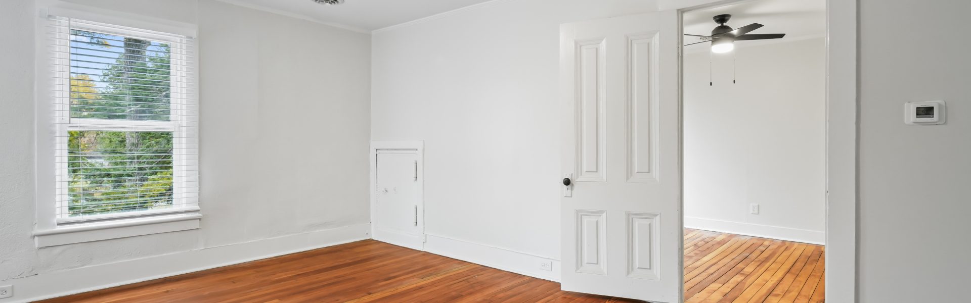 Interior view of a newly renovated 2-bedroom apartment at 58 Lincoln Ave #2 in Saratoga Springs, NY, featuring a balcony, dedicated office space, and modern finishes.