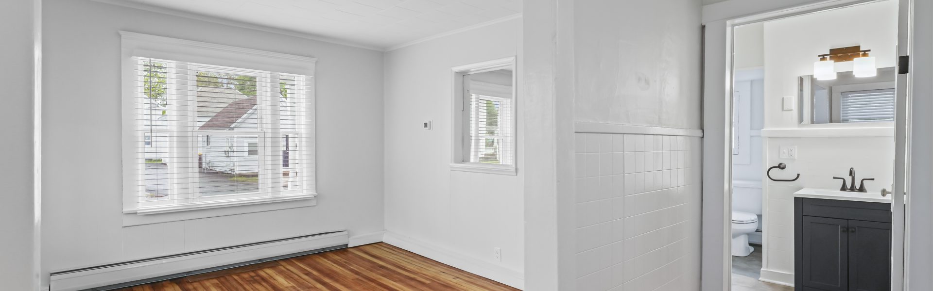 Interior view of a newly renovated 1-bedroom apartment at 2 New St #3 in South Glens Falls, NY with updated flooring and modern finishes.