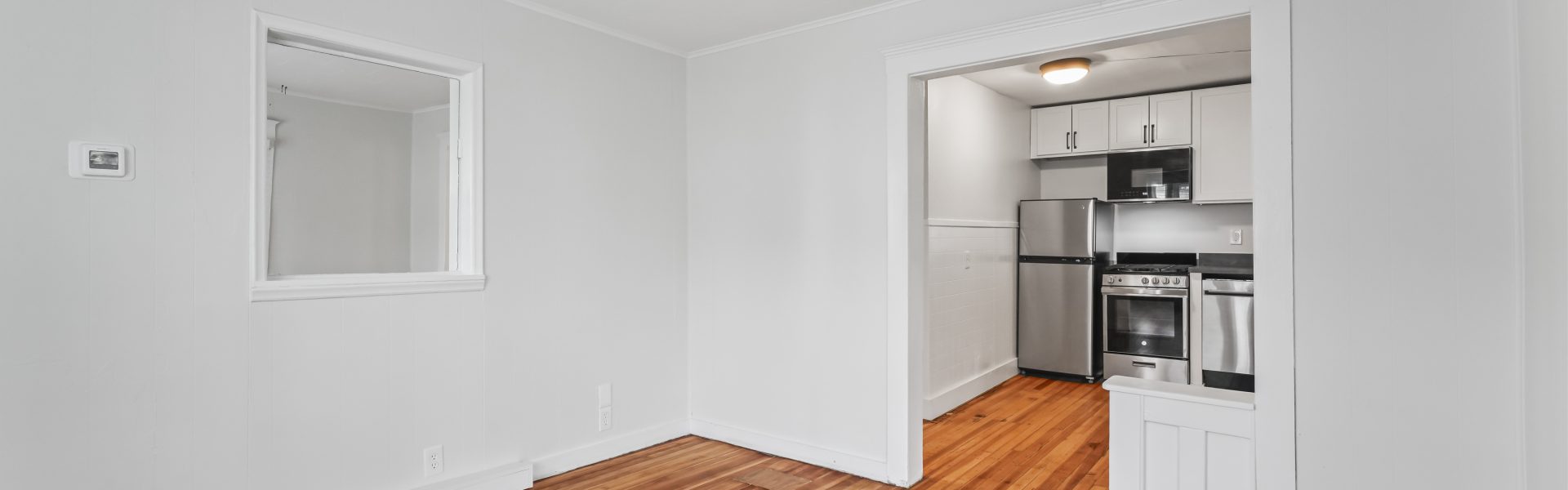 Interior view of a newly renovated 1-bedroom apartment at 2 New St #3 in South Glens Falls, NY with updated flooring and modern finishes.