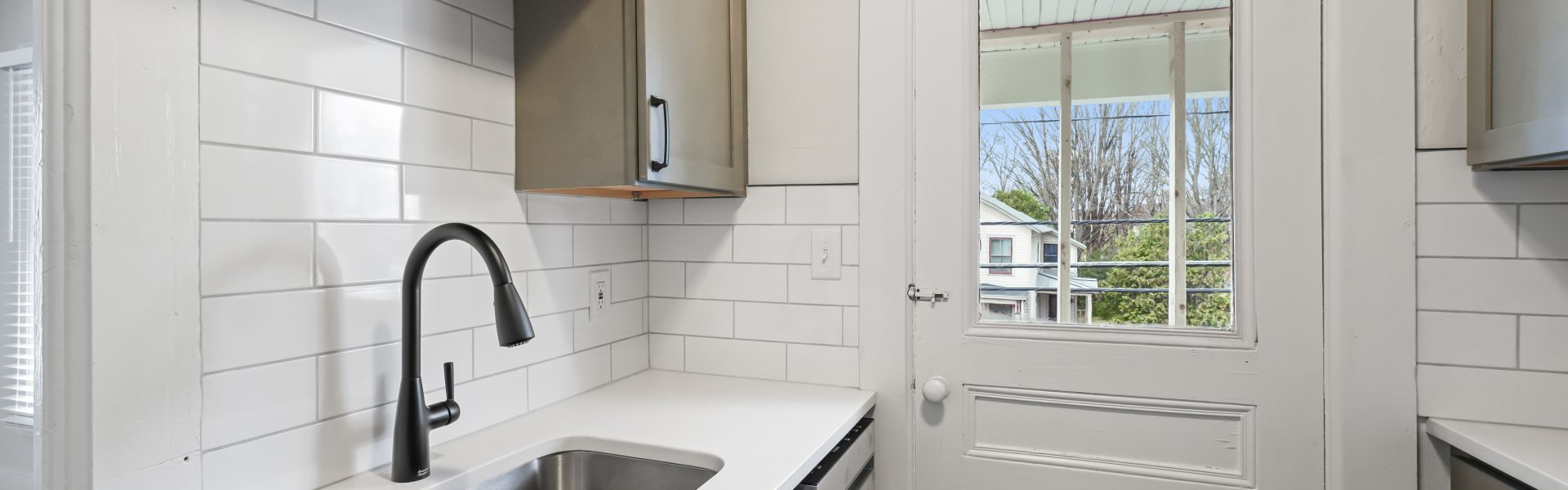 Interior view of the modern studio apartment at 58 Lincoln Ave #3 in Saratoga Springs, NY, featuring a private balcony and updated finishes near downtown.