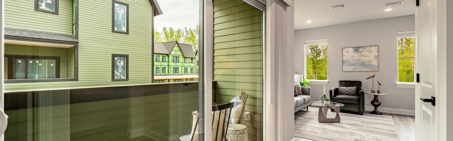 Corridor inside The Ridge residence with window overlooking balcony and exterior view