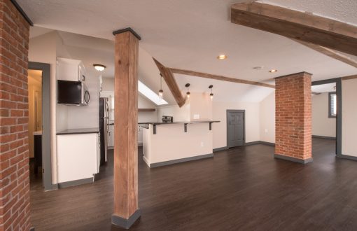 Spacious undecorated living room with open layout and natural light