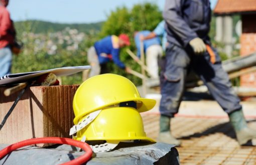 Commercial maintenance workers on a job site with safety helmets and tools, representing third-party property maintenance services