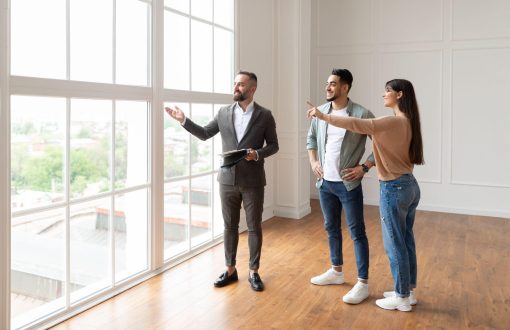 Couple touring a rental apartment with a Green Springs Property Management representative during a guided showing.