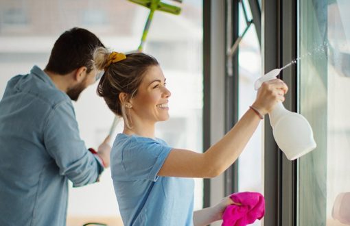 Couple cleaning their rental apartment together as part of seasonal maintenance and long-term renter upkeep.